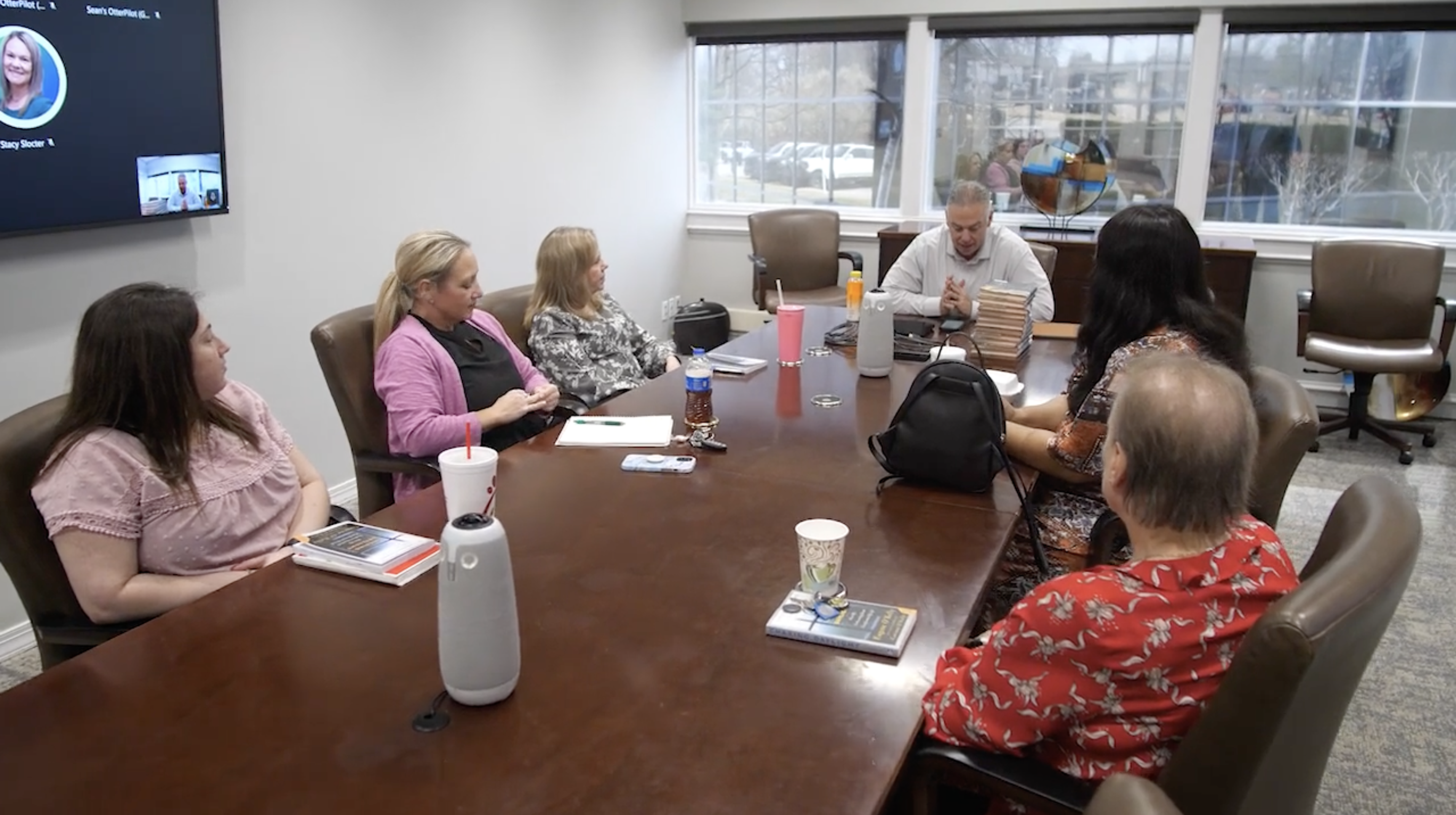 employees sit around at table for bible study